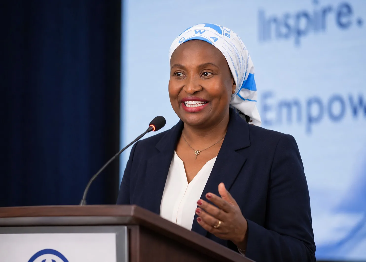 Monica Wanjohi speaking on stage as a Family Character Coach